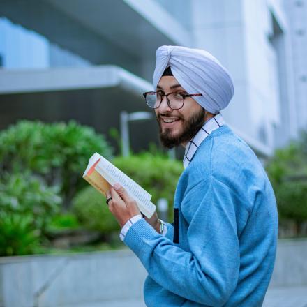 Man in a turban reading a book